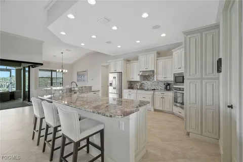 a kitchen with kitchen island cabinets and refrigerator