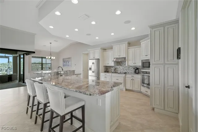 a kitchen with kitchen island cabinets and refrigerator