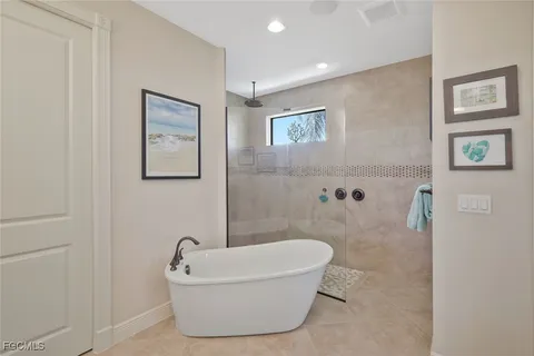 a bathroom with a tub and a shower