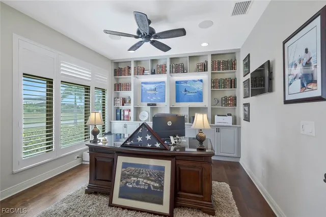 a living room with stainless steel appliances granite countertop furniture and a wooden floor