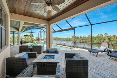 a living room with furniture city view and large windows