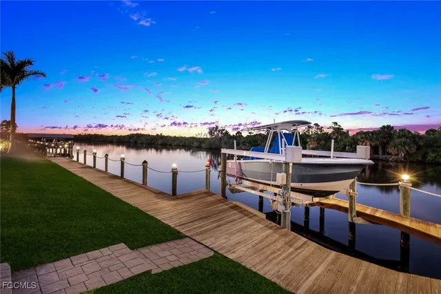 a view of a lake with couches in front of house