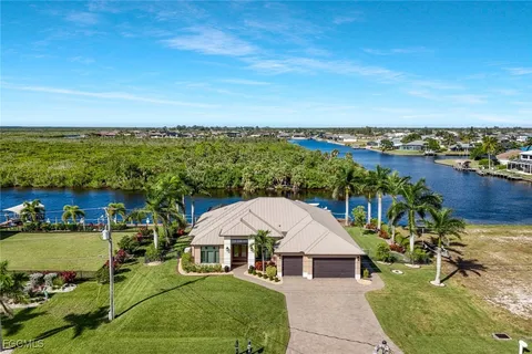 a view of a house with a yard and lake view