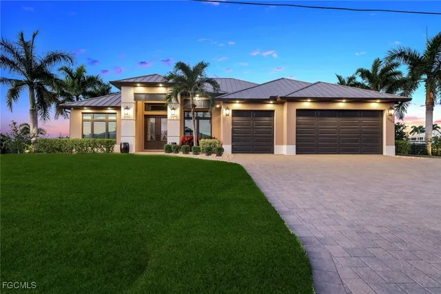 a front view of a house with a yard and a garage