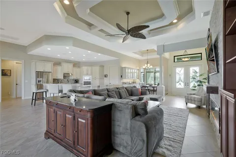 a living room with lots of furniture and a large window