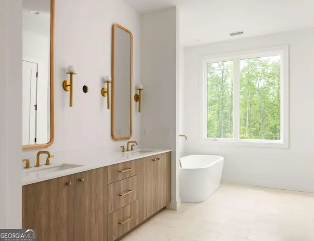 a bathroom with a double vanity sink a toilet and a window