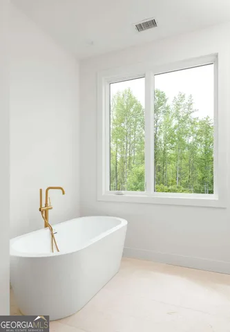 a bathroom with a bathtub and window