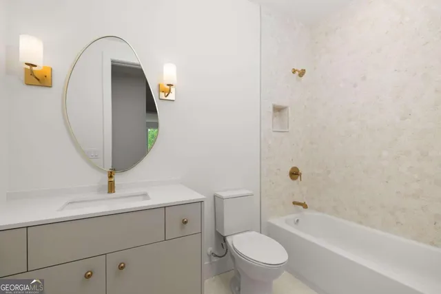 a bathroom with a sink a toilet and bathtub