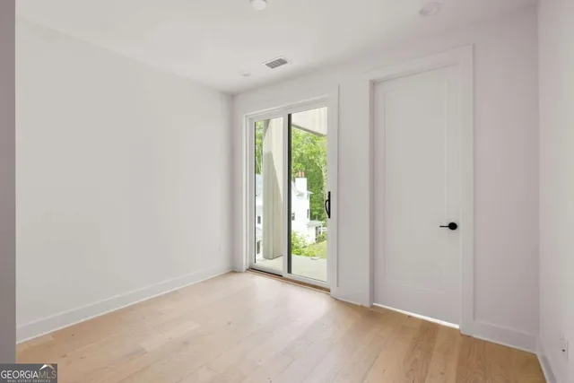 a view of an empty room with glass door