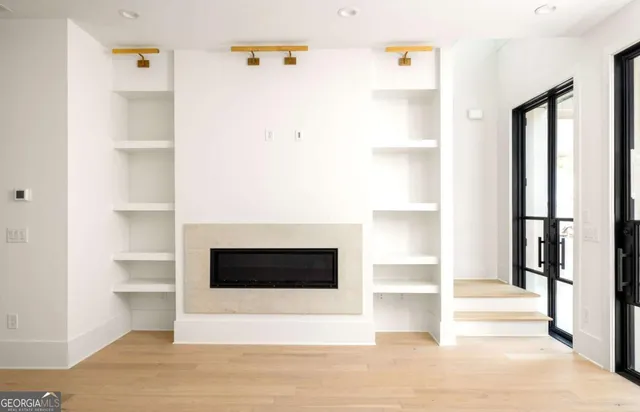 a view of a room with wooden floor and windows