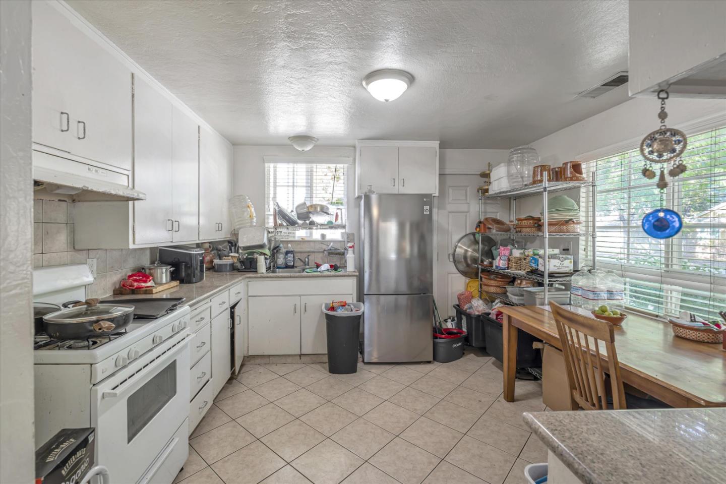 1019 Gemini Court Modesto, CA 95355 - Photo 4 of 10 a kitchen that has a lot of cabinets in it and appliances
