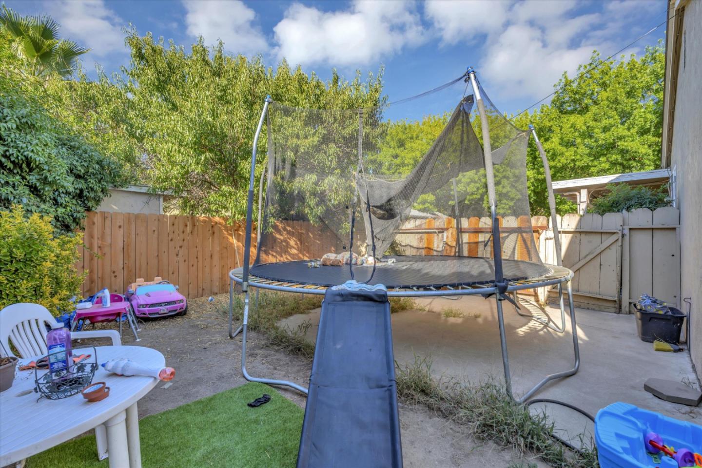 1019 Gemini Court Modesto, CA 95355 - Photo 9 of 10 a backyard of a house with table and chairs