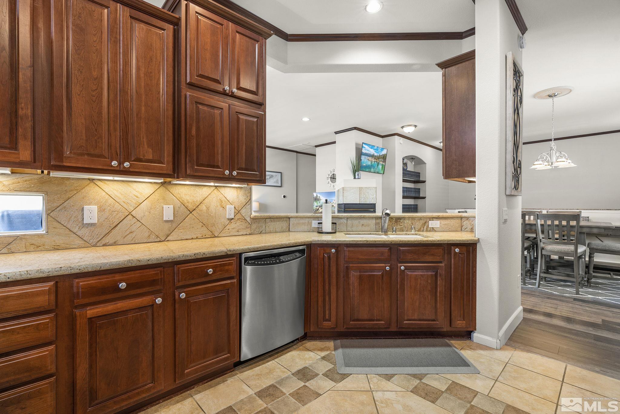 9900 Wilbur May Parkway, Unit 2404 Reno, NV 89521 - Photo 13 of 36 a kitchen with stainless steel appliances granite countertop a sink and cabinets