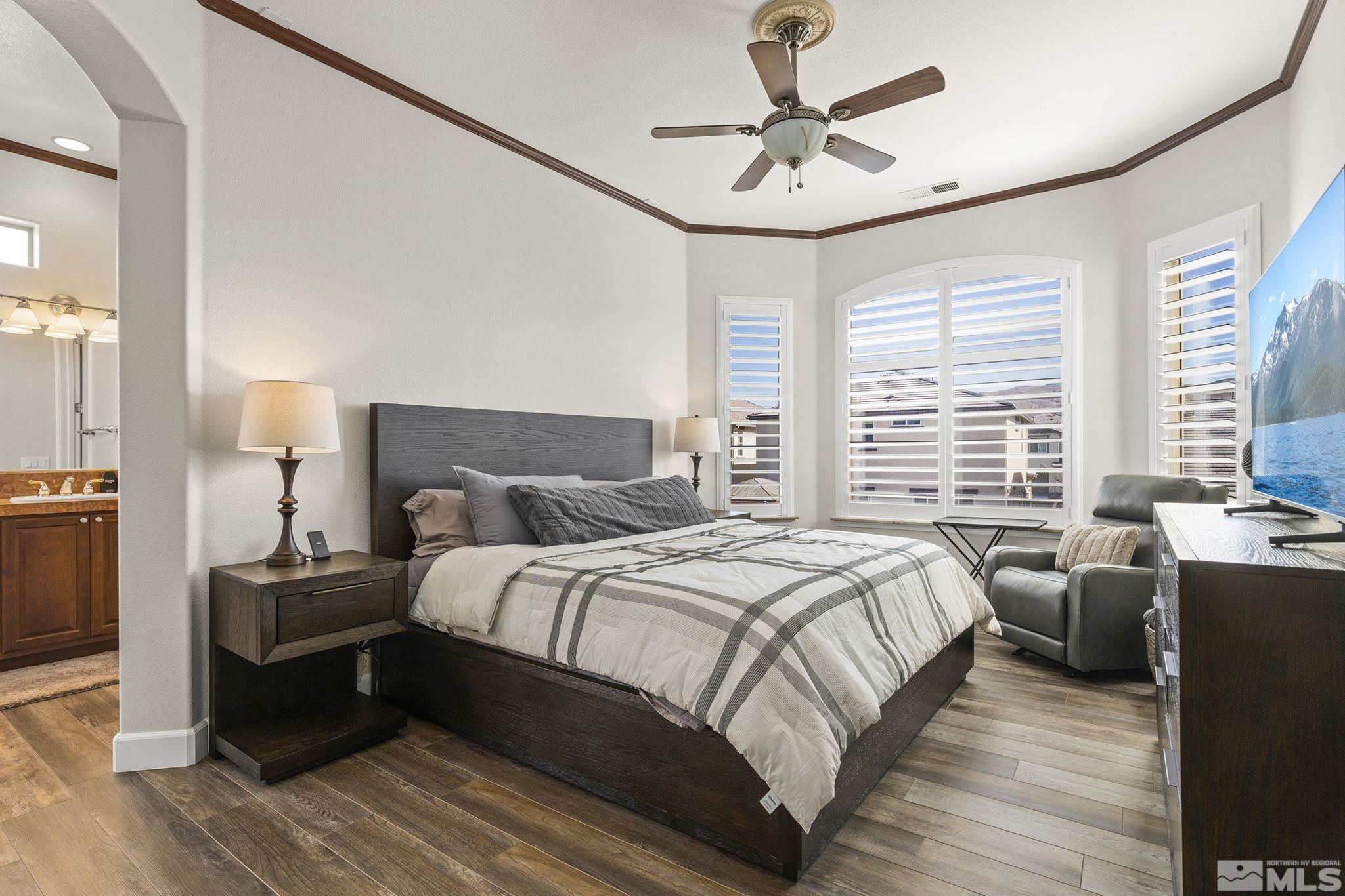 9900 Wilbur May Parkway, Unit 2404 Reno, NV 89521 - Photo 14 of 36 a bedroom with a bed and wooden floor