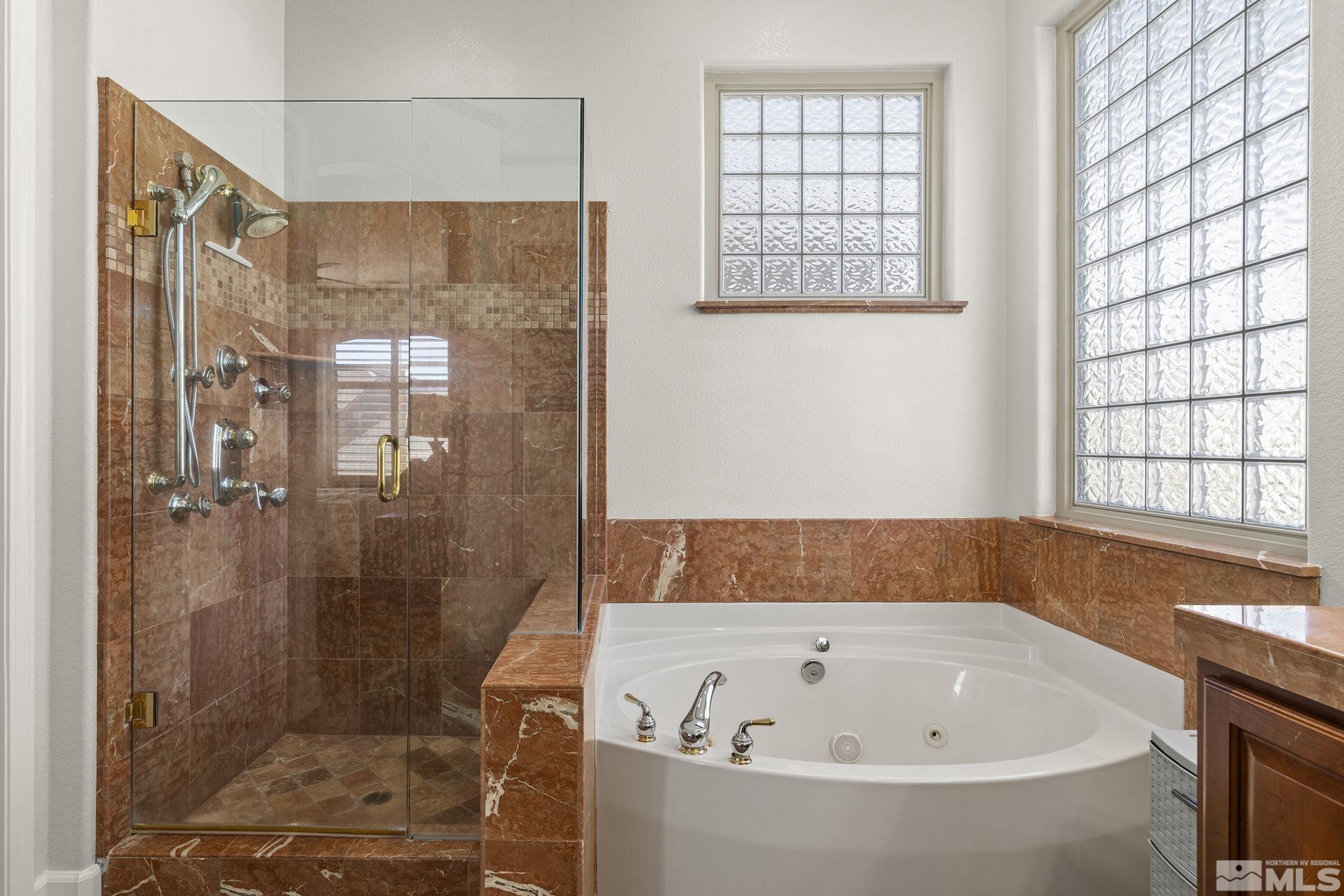 9900 Wilbur May Parkway, Unit 2404 Reno, NV 89521 - Photo 16 of 36 a bathroom with a bathtub and shower