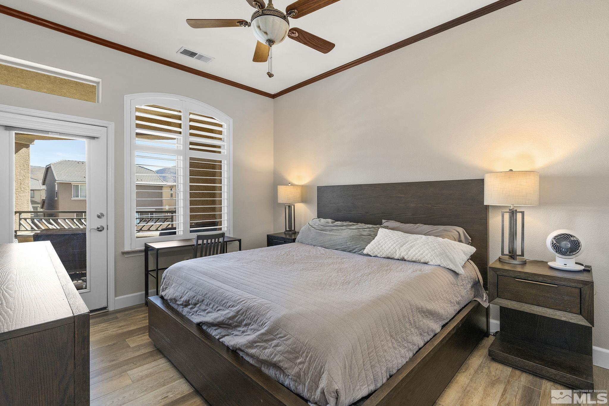 9900 Wilbur May Parkway, Unit 2404 Reno, NV 89521 - Photo 17 of 36 a bedroom with a large bed and a chandelier