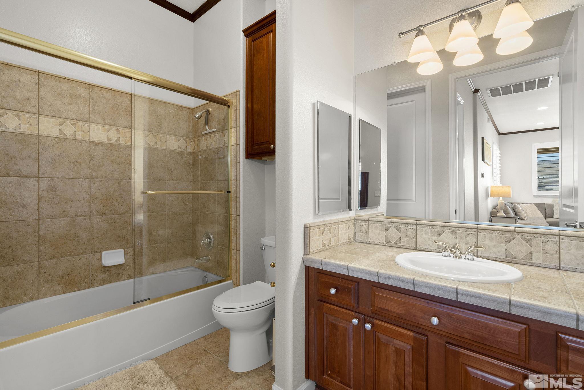 9900 Wilbur May Parkway, Unit 2404 Reno, NV 89521 - Photo 18 of 36 a bathroom with a sink a toilet and shower