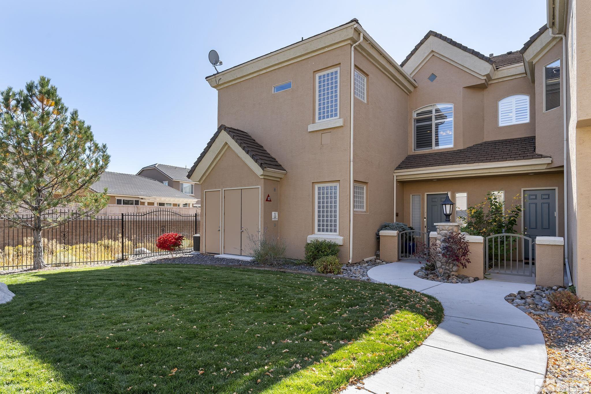 9900 Wilbur May Parkway, Unit 2404 Reno, NV 89521 - Photo 2 of 36 a front view of a house with a yard and porch