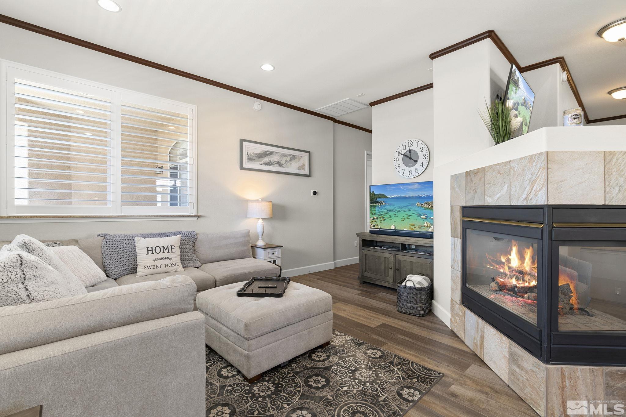 9900 Wilbur May Parkway, Unit 2404 Reno, NV 89521 - Photo 9 of 36 a living room with furniture and a fireplace