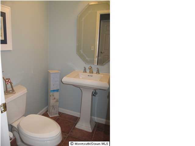 45 Sweet Gum Road Howell, NJ 07731 - Photo 13 of 25 a bathroom with a sink a toilet and mirror