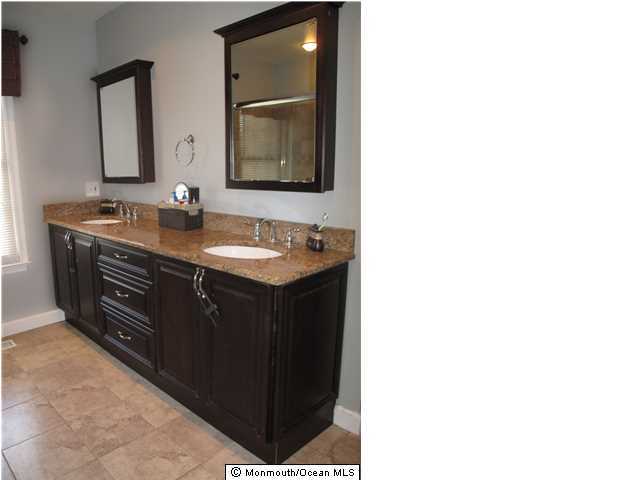 45 Sweet Gum Road Howell, NJ 07731 - Photo 17 of 25 a bathroom with a double vanity sink and mirror