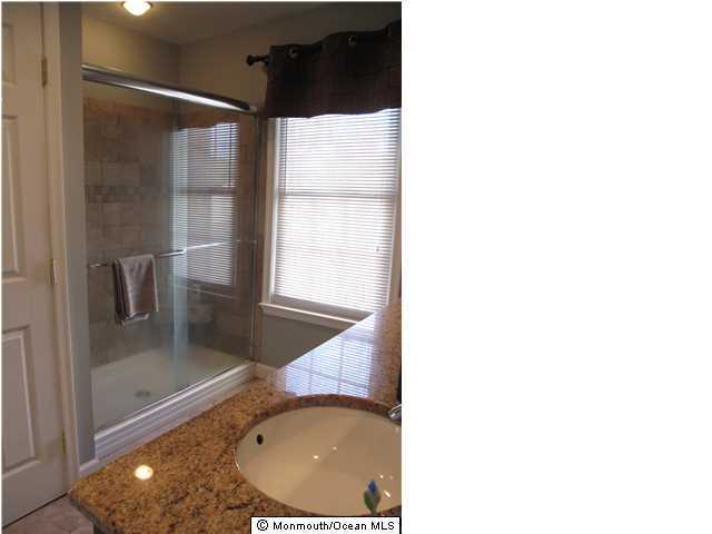 45 Sweet Gum Road Howell, NJ 07731 - Photo 18 of 25 a bathroom with a sink and mirror