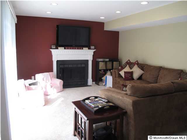 45 Sweet Gum Road Howell, NJ 07731 - Photo 9 of 25 a living room with furniture a flat screen tv and a fireplace