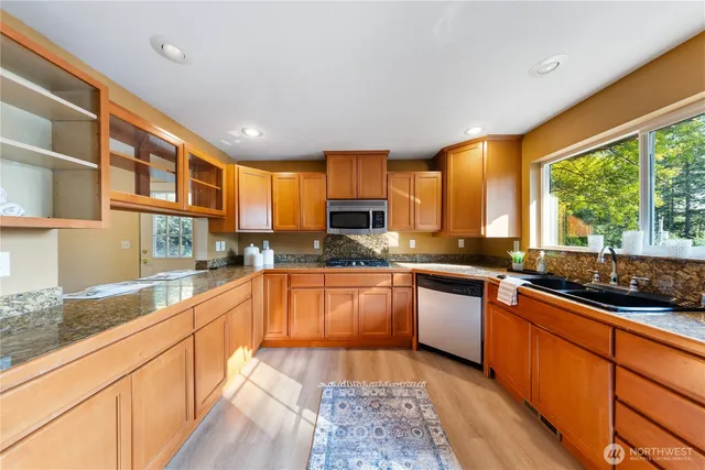 a kitchen with a sink stove and cabinets