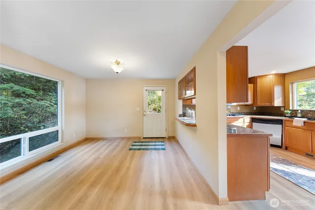 a large kitchen with stainless steel appliances granite countertop a refrigerator a stove top oven and a sink with granite countertops