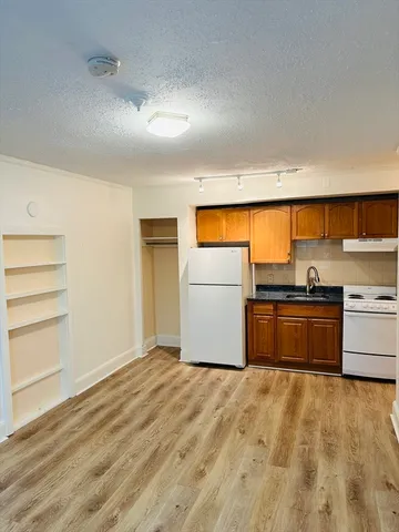 a kitchen with a refrigerator and a stove