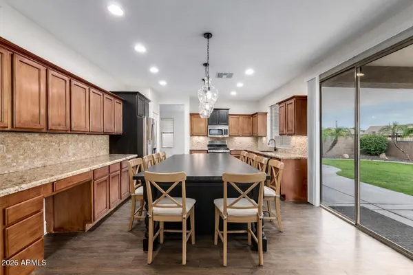an empty room with wooden floor and ceiling fan