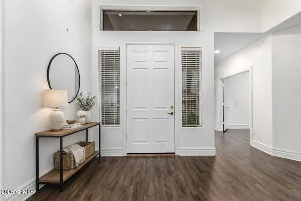 a view of entryway and hall with wooden floor