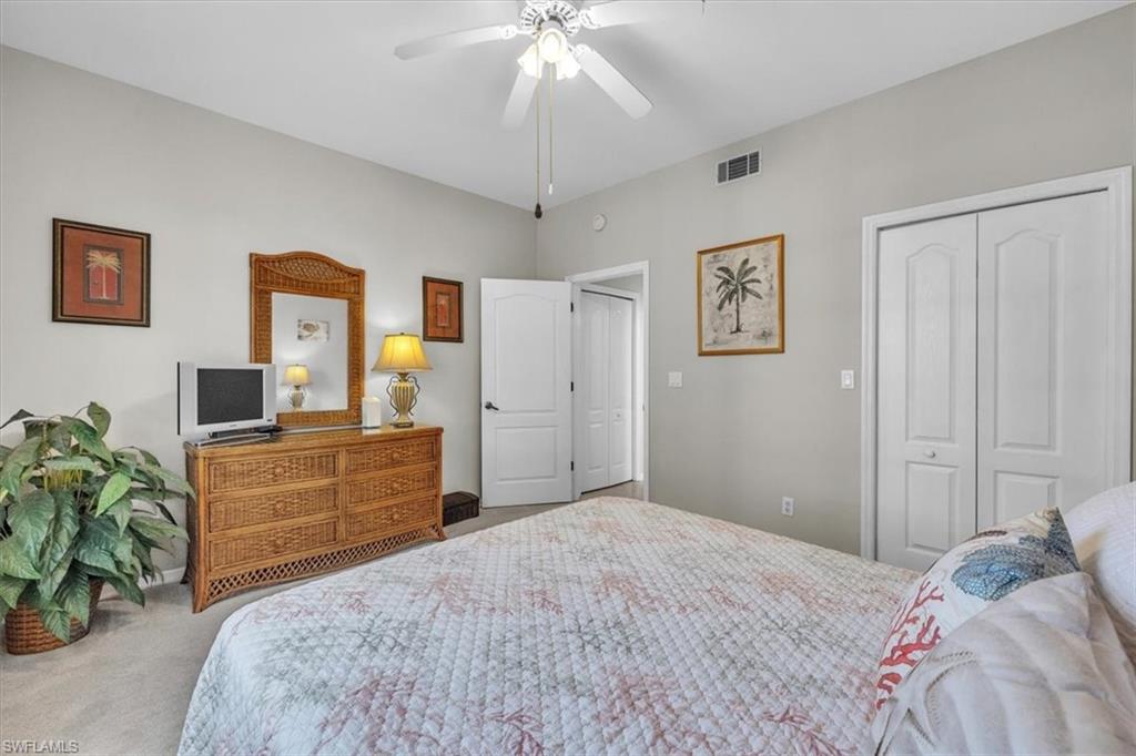 8075 Tiger Cove, Unit 1706 Naples, FL 34113 - Photo 30 of 50 Carpeted bedroom featuring a closet and a ceiling fan