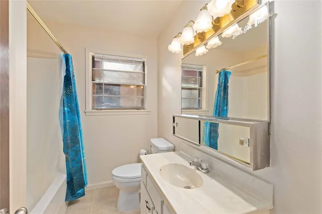 a bathroom with a sink toilet and mirror