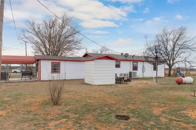a view of a house with a yard covered in snow
