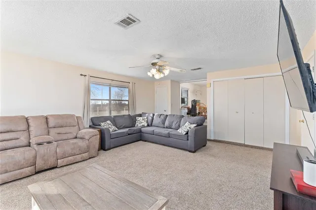 a living room with furniture and a large mirror