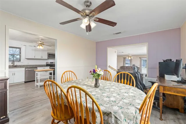 a dining room with furniture and a flat screen tv