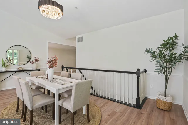 a view of a dining room with furniture and a chandelier