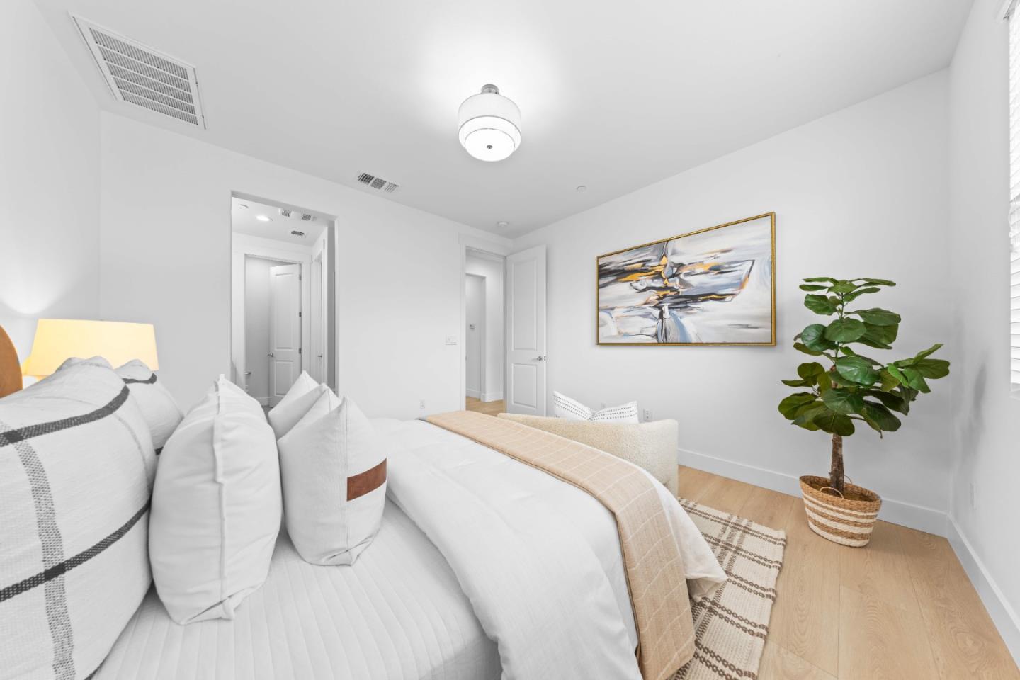 856 Sycamore Loop Mountain View, CA 94043 - Photo 16 of 27 a bedroom with a bed and a potted plant