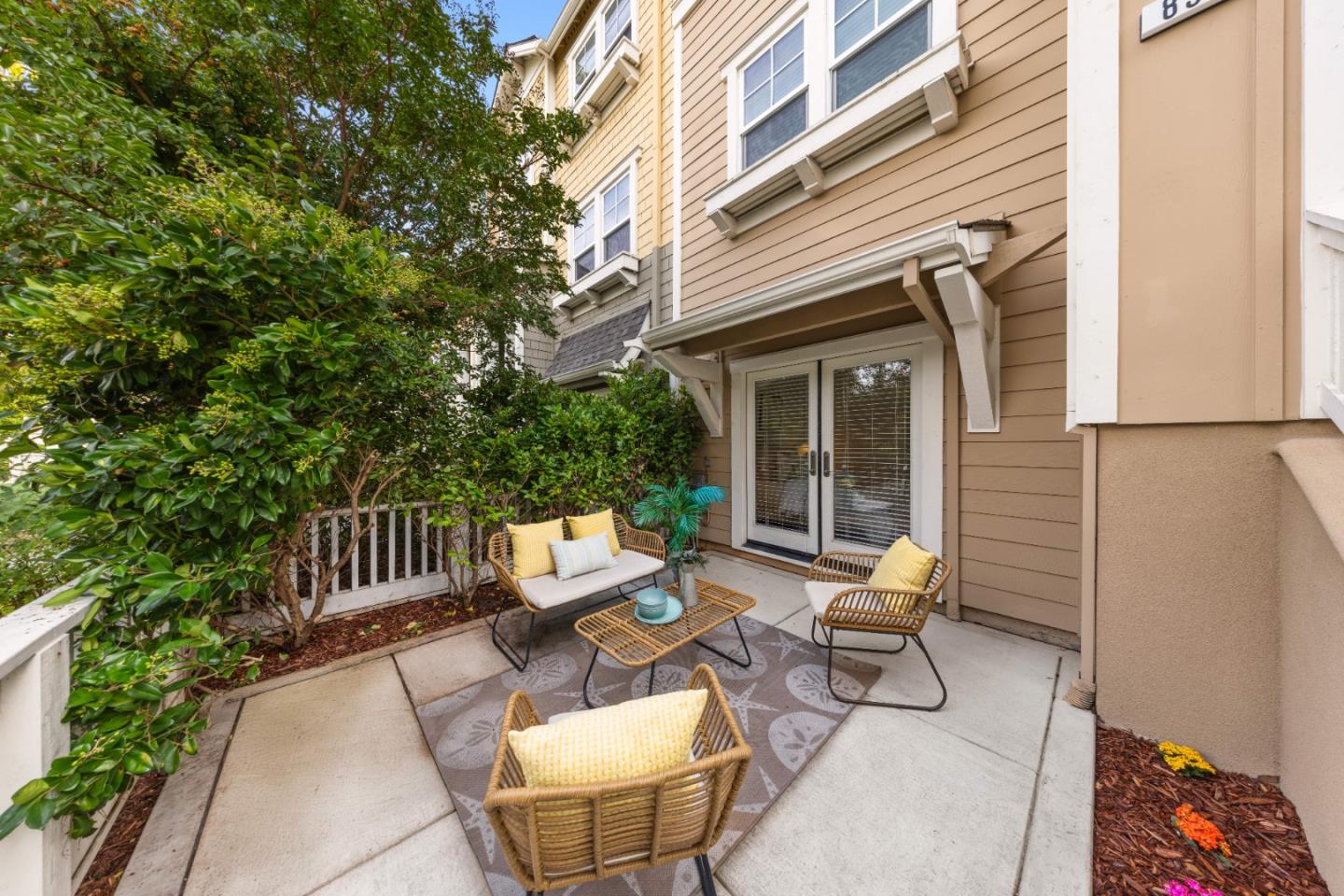 856 Sycamore Loop Mountain View, CA 94043 - Photo 26 of 27 a view of a patio with a table and chairs and floor to ceiling window plants and wooden fence