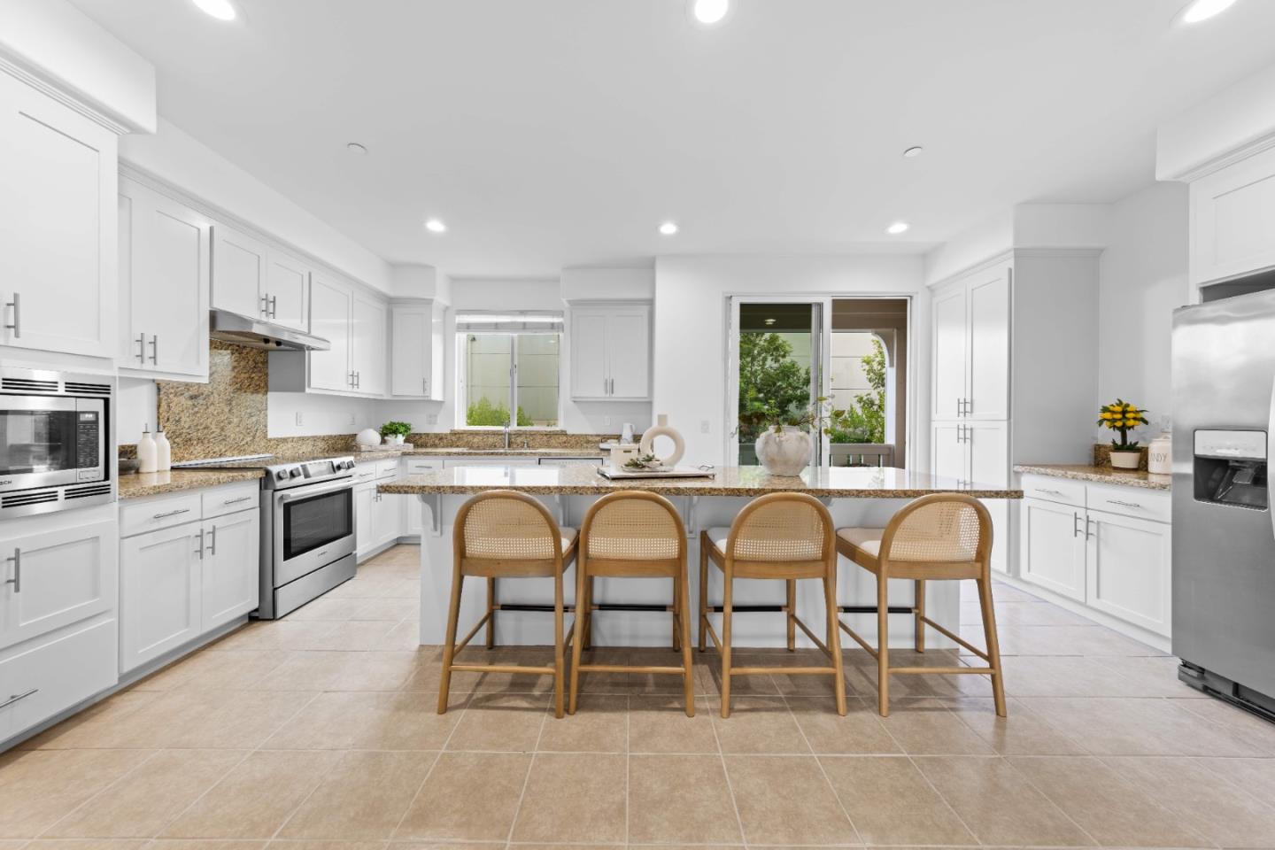 856 Sycamore Loop Mountain View, CA 94043 - Photo 6 of 27 a kitchen with stainless steel appliances granite countertop a table chairs sink and window