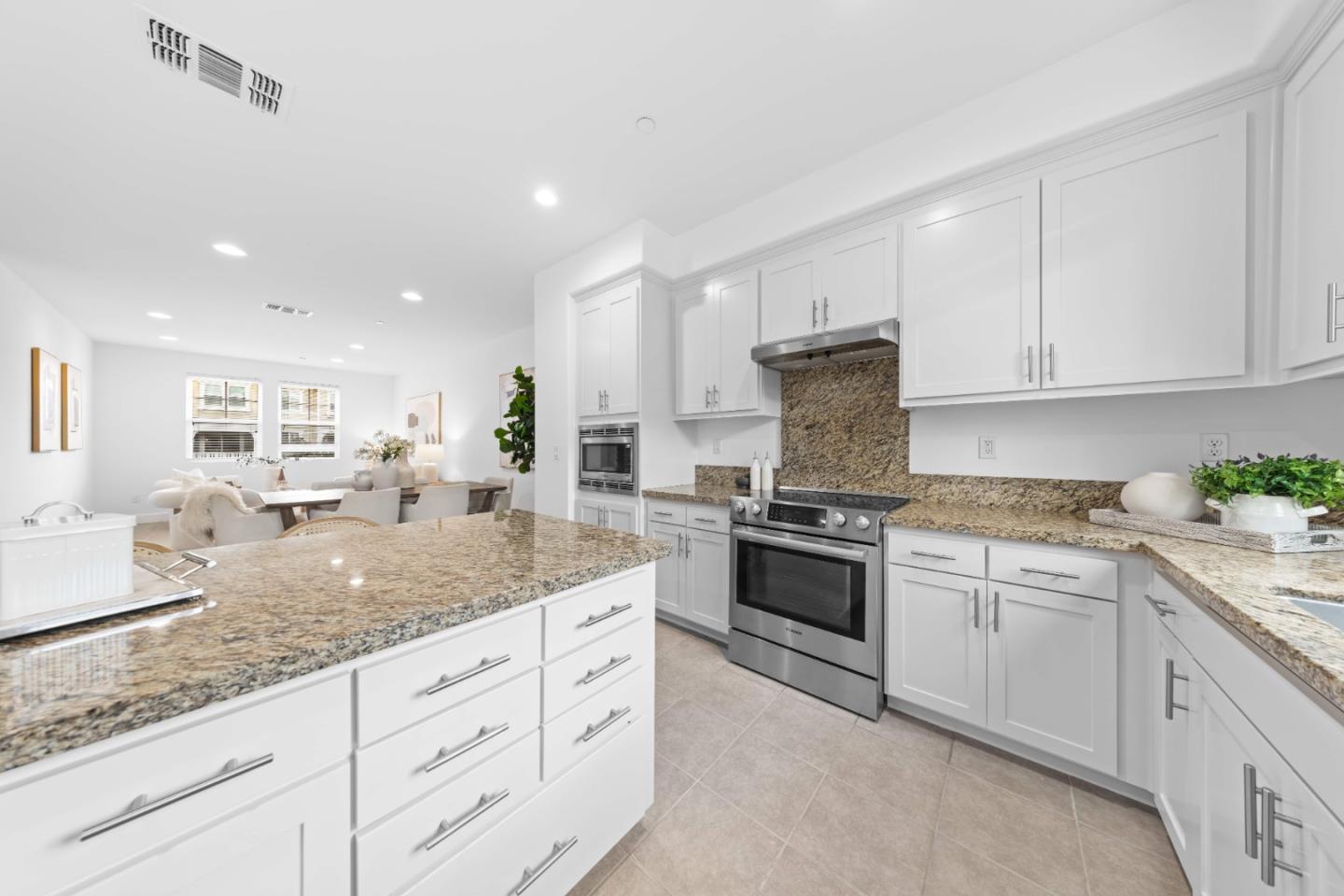 856 Sycamore Loop Mountain View, CA 94043 - Photo 8 of 27 a kitchen with granite countertop white cabinets and a stainless steel appliances