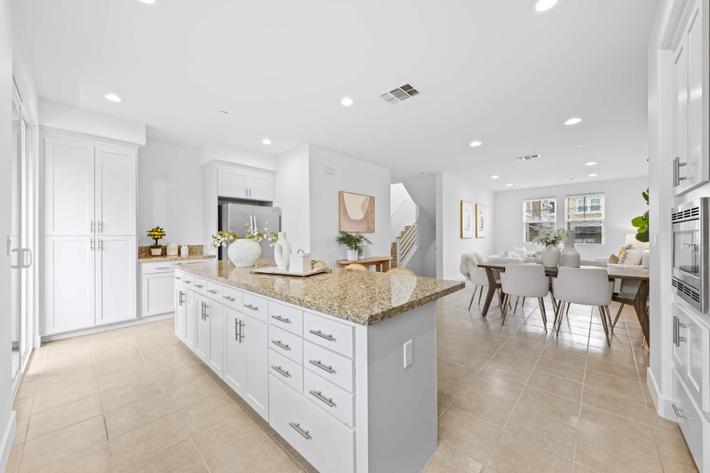 856 Sycamore Loop Mountain View, CA 94043 - Photo 9 of 27 a kitchen with stainless steel appliances kitchen island granite countertop a table and chairs in it