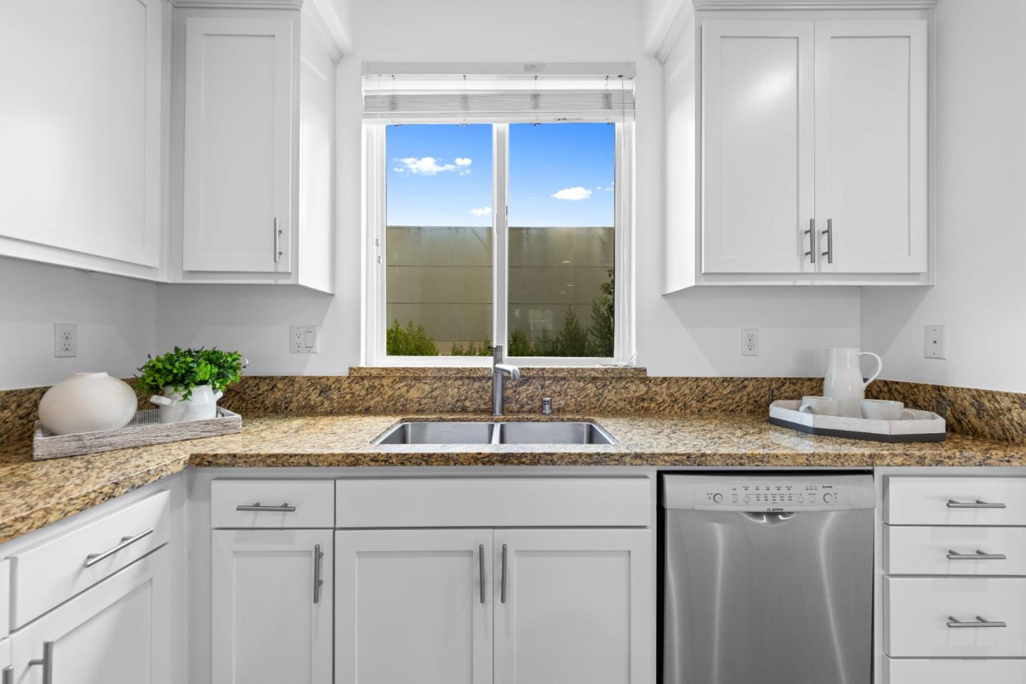 856 Sycamore Loop Mountain View, CA 94043 - Photo 10 of 27 a kitchen with granite countertop a sink and cabinets