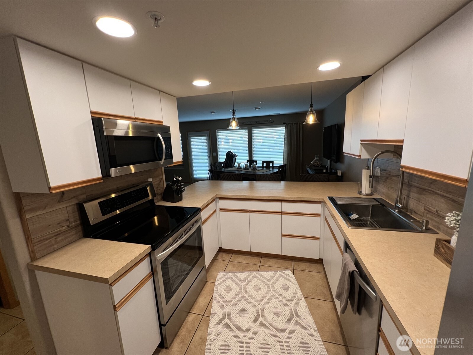 8997 Crescent Bar Road Northwest, Unit C118 Quincy, WA 98848 - Photo 11 of 33 a kitchen that has a sink and a stove in it
