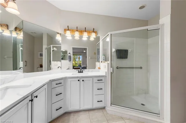 a spacious bathroom with a shower sink and mirror