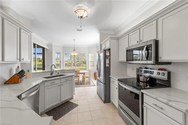 a kitchen with stainless steel appliances a sink stove and refrigerator