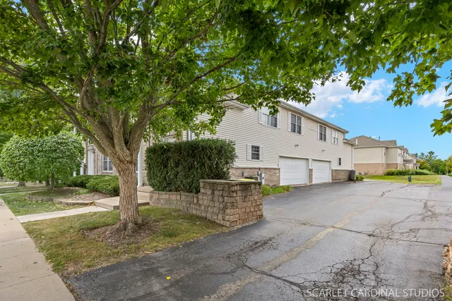 a white house that has tree in front of it