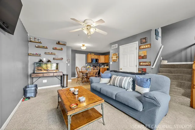a living room with furniture and wooden floor