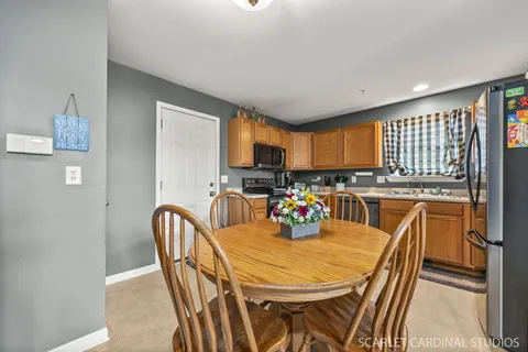 a view of a dining room with furniture and a kitchen view